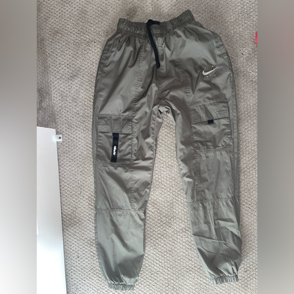 Olive green Nike cargo Windbreaker pants.